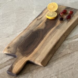 Handcrafted live edge charcuterie board with dark and light grain and elegant handle