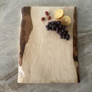 Handcrafted live edge maple charcuterie board with a beautiful grain pattern that captures your eye.