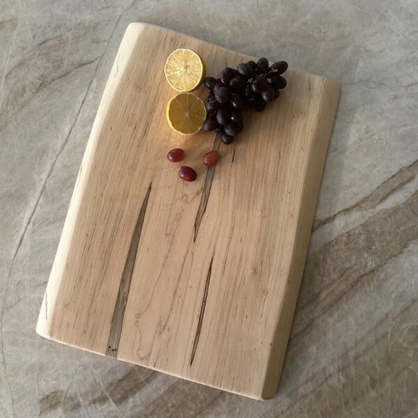 Handcrafted live edge spalted poplar charcuterie board with a beautiful grain pattern that captures your eye.
