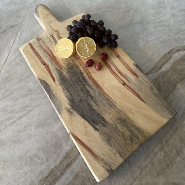 Handcrafted live edge spalted maple charcuterie board with a beautiful grain pattern that captures your eye.